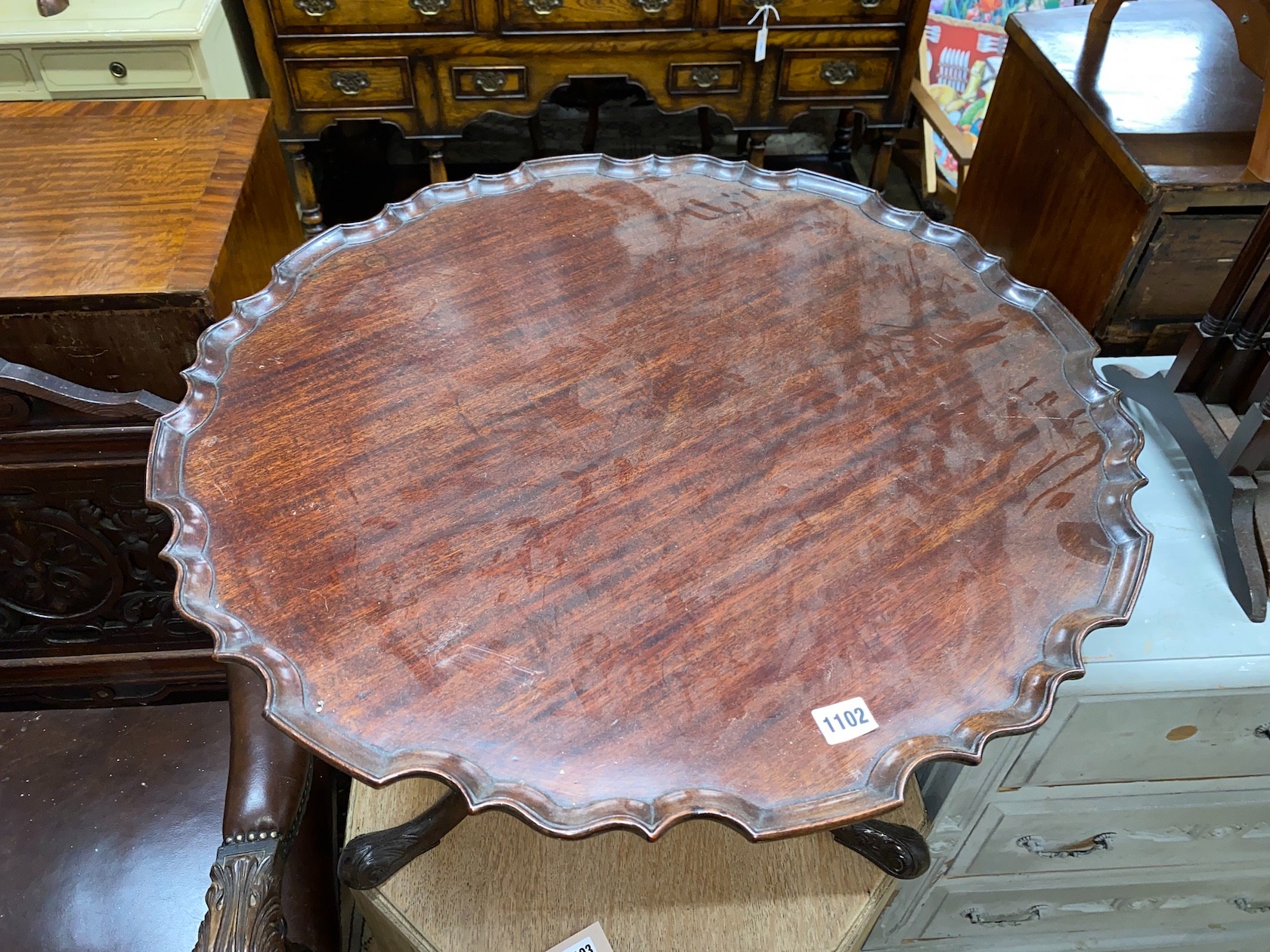 A George III and later circular piecrust occasional table, cut-down, diameter 70cm, height 50cm together with a nest of three Edwardian mahogany tea tables